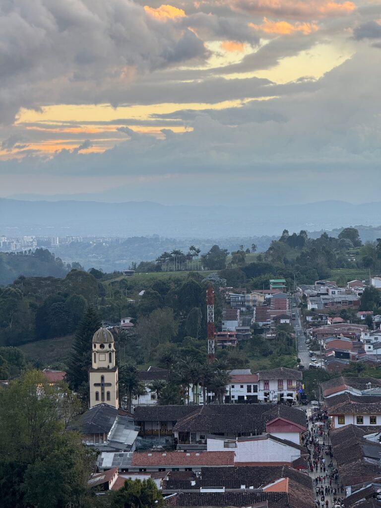 View from a different angle at the Mirador viewpoint in Salento, Colombia, showing the colorful town rooftops and surrounding rolling coffee hills