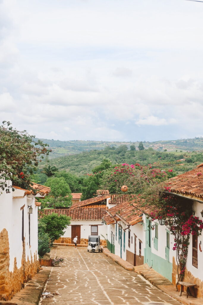 Cobblestone street in Barichara with white stone houses and wooden doors in Colombia. Best things to do in San Gil