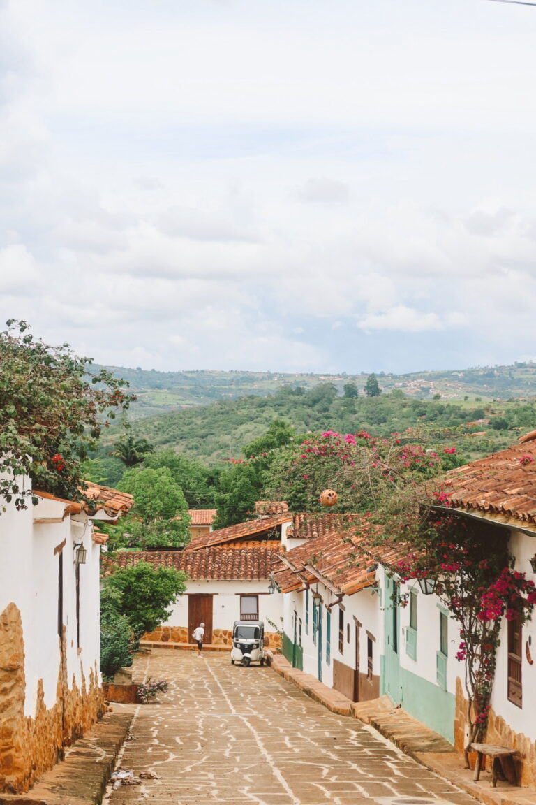 Cobblestone street in Barichara with white stone houses and wooden doors in Colombia. Best things to do in San Gil