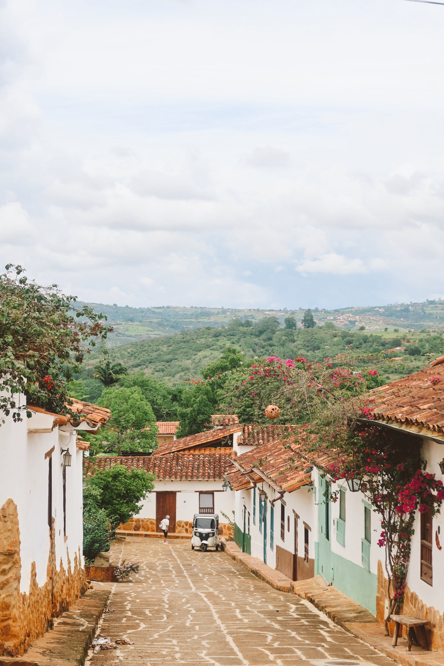 Cobblestone street in Barichara with white stone houses and wooden doors in Colombia. Best things to do in San Gil