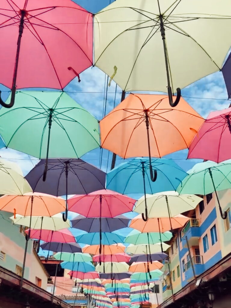 Colourful umbrellas hanging above Calle de Recuerdo in Guatape