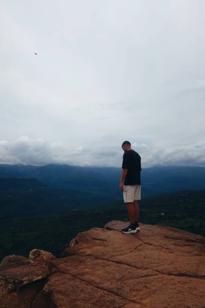 Person standing at a viewpoint overlooking Chicamocha Canyon in Colombia