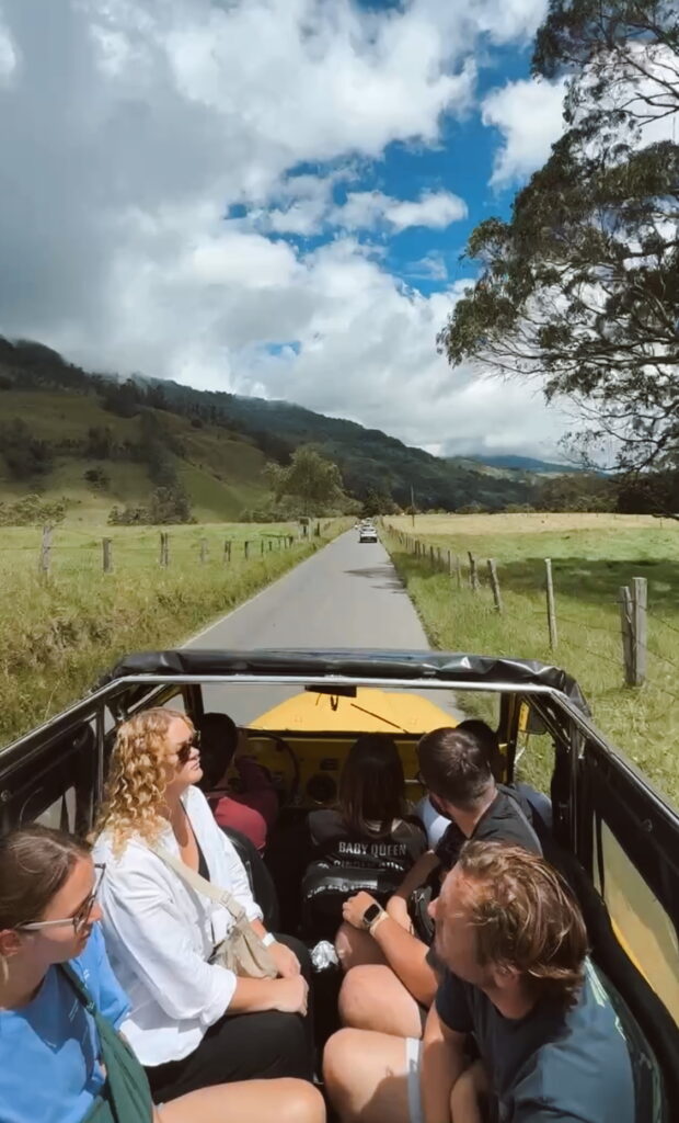 Tourists enjoying a scenic ride in a Willy jeep from Salento to Cocora Valley