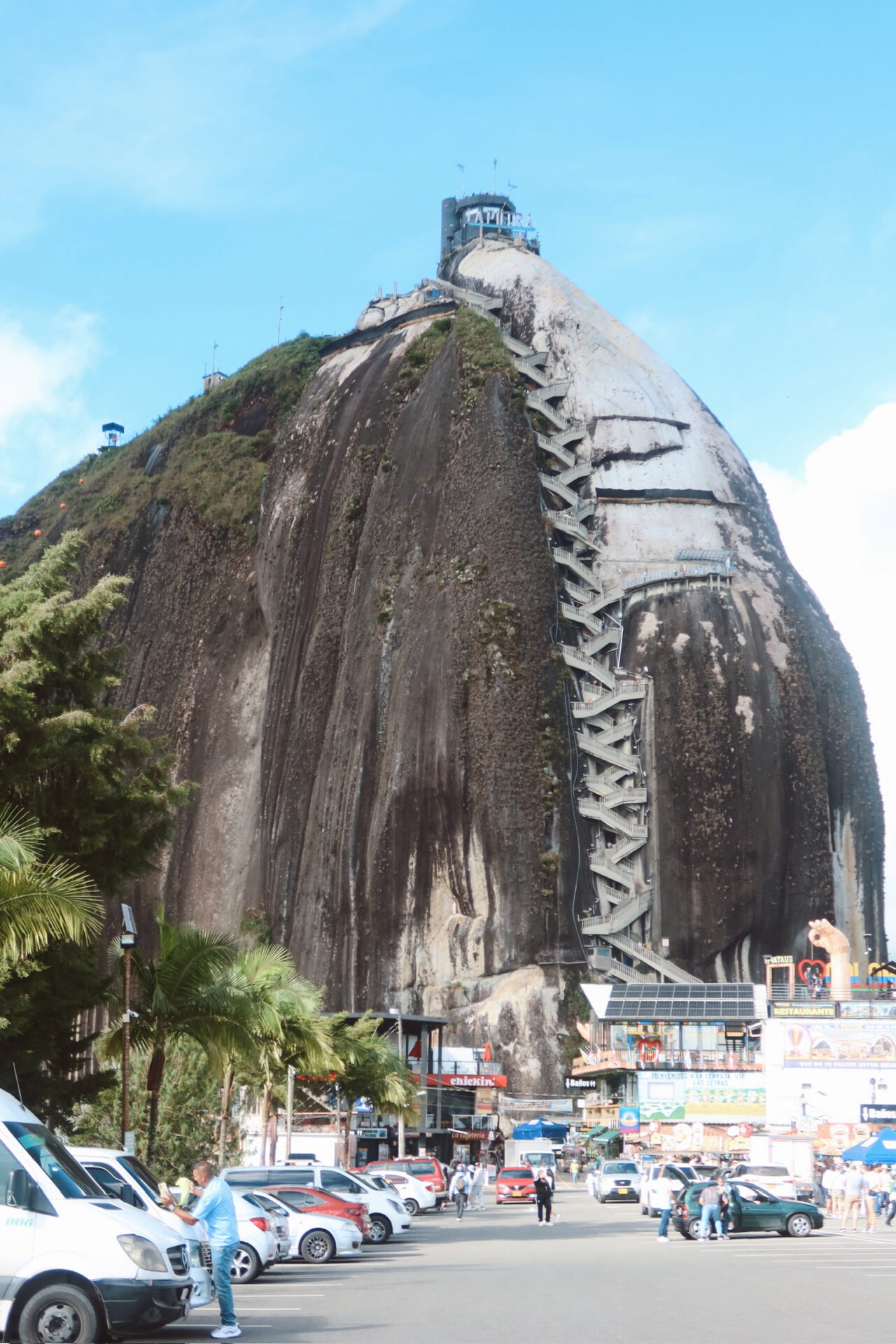 El Penol Rock Guatape viewed from the ground with green hills around it