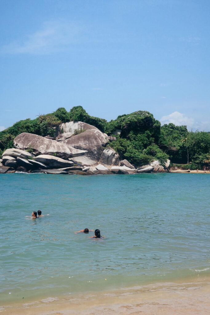 Cabo San Juan beach in Tayrona National Park, Colombia, with blue Caribbean water and rocky lookout