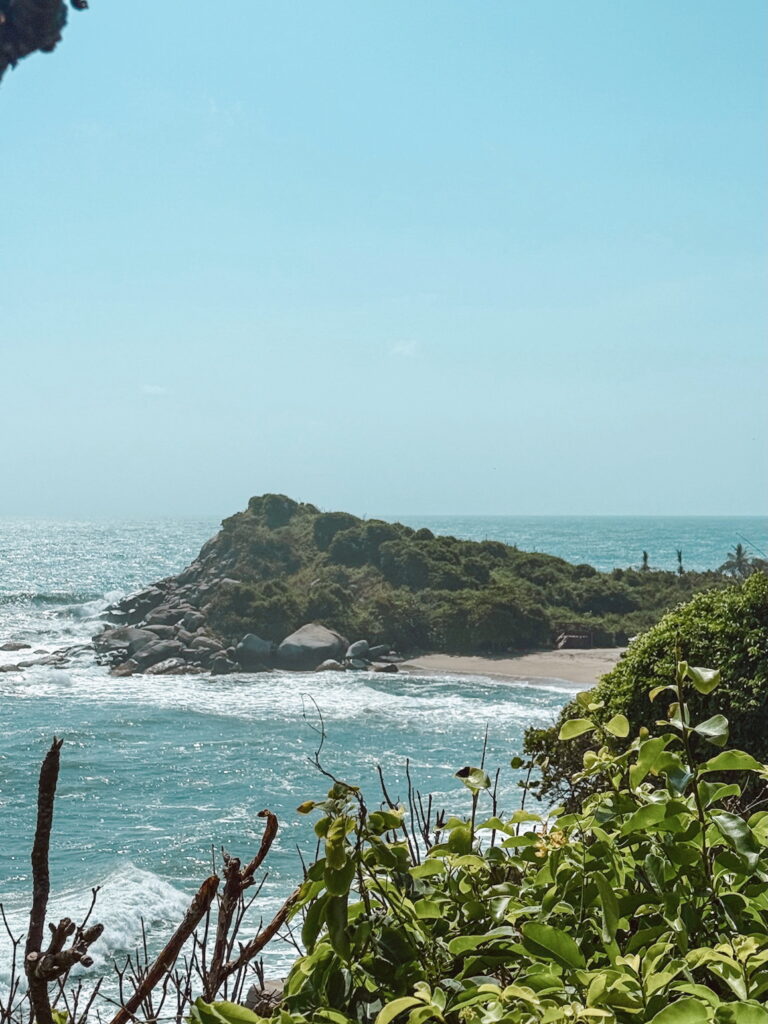Arrecifes beach in Tayrona National Park with dramatic rocks and forest backdrop