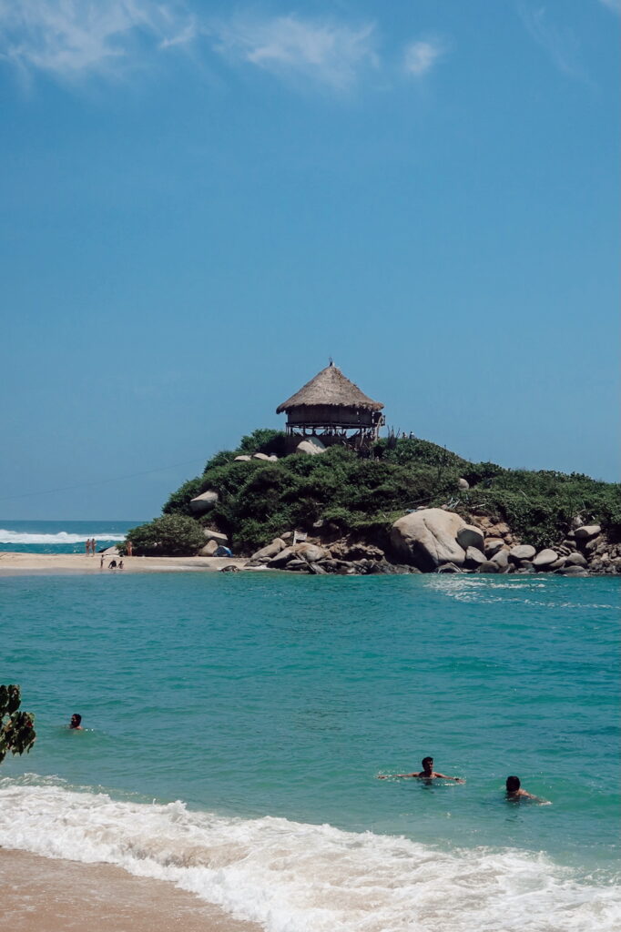 Beach in Tayrona National Park, Colombia with turquoise water and jungle hills