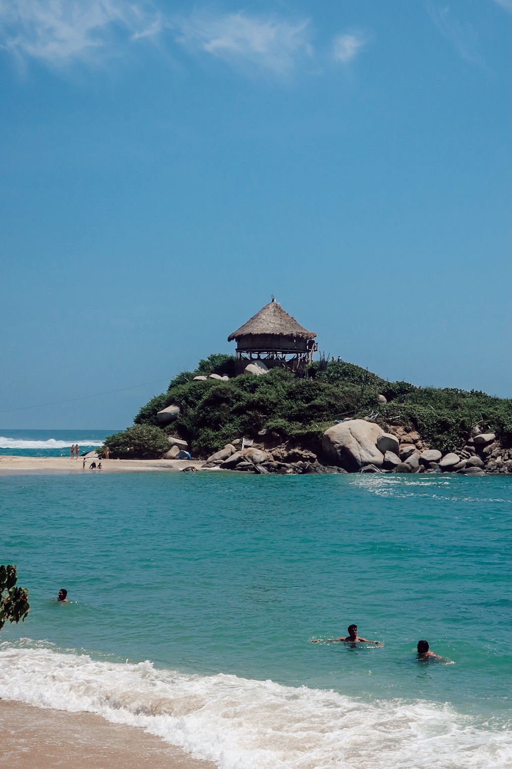 Beach in Tayrona National Park, Colombia with turquoise water and jungle hills