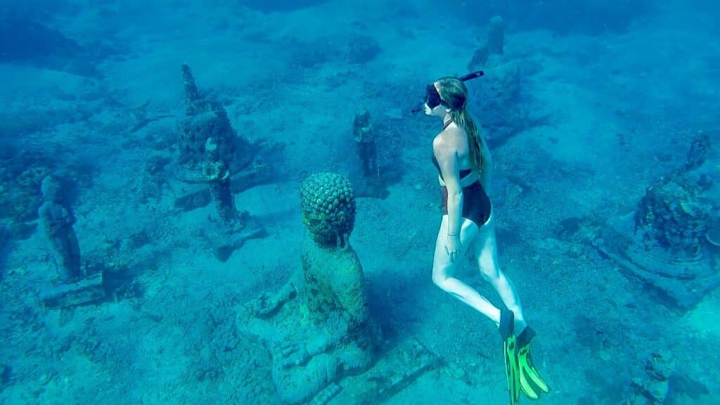 Katie, founder of Where Katie Goes, snorkeling at the underwater statues in Nusa Penida, Bali.