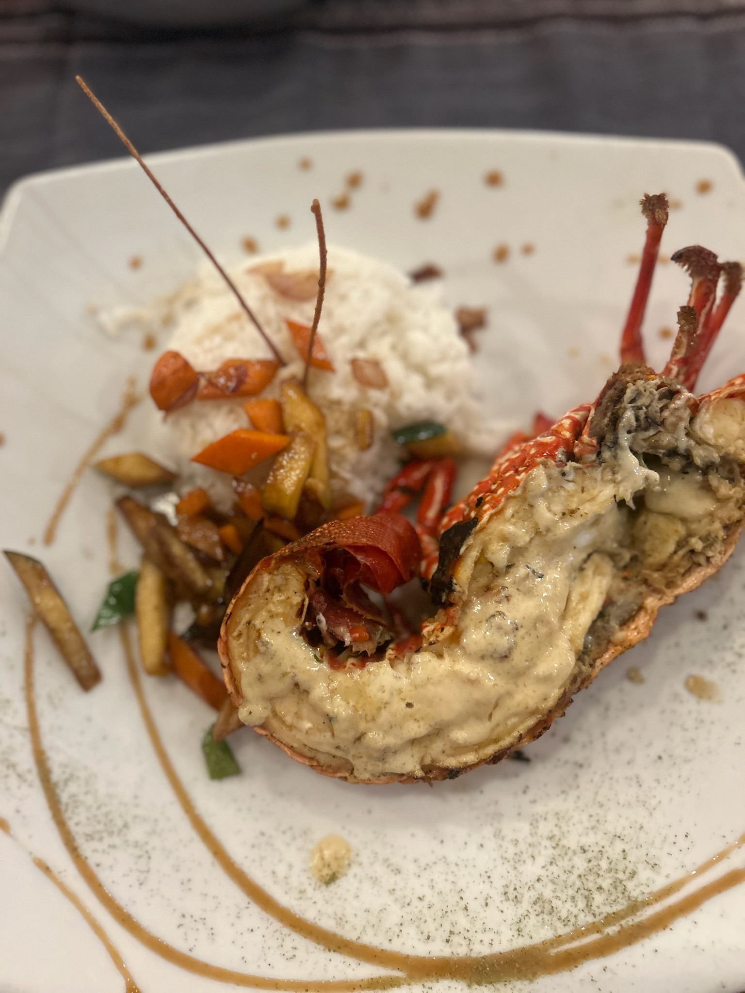 A fresh grilled lobster dinner served as a local menu of the day special in Puerto Villamil