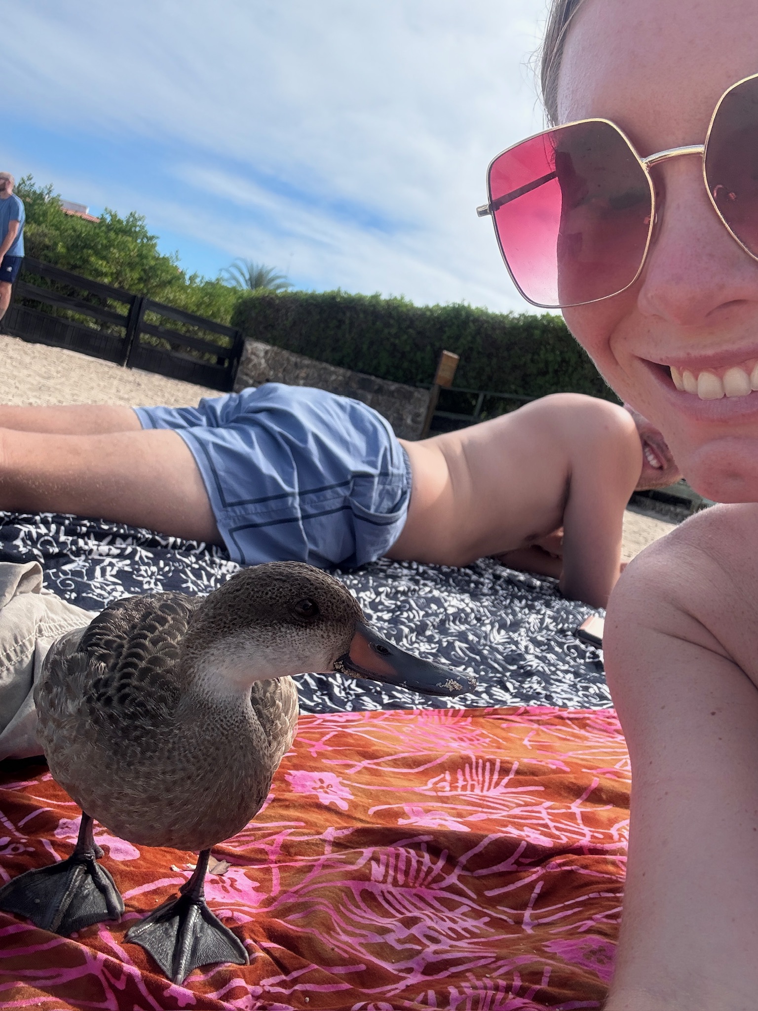 A travel blogger taking a selfie with a duck on the beach trail leading to Las Grietas.